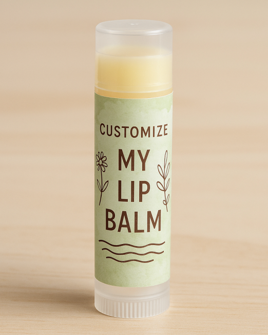 A realistic lip balm tube with a pale green custom label featuring hand-drawn botanical designs and bold dark brown text, placed on a natural wood surface with soft lighting.
